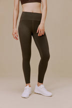 Woman wearing dark green leggings