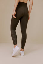 Woman wearing dark green leggings
