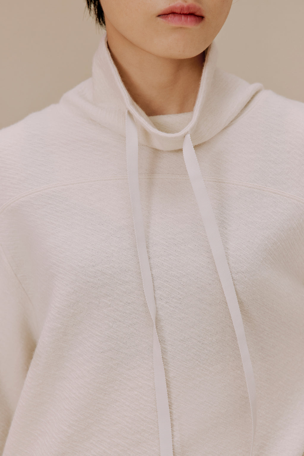 Woman in white pullover