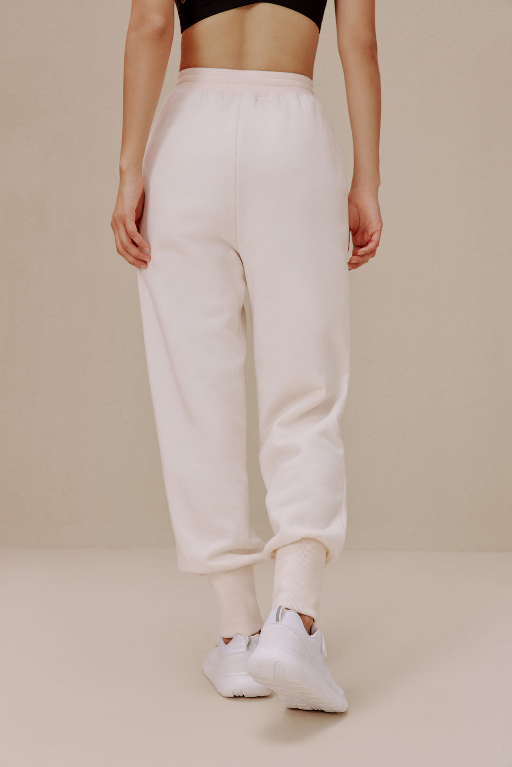 back of women in white pants