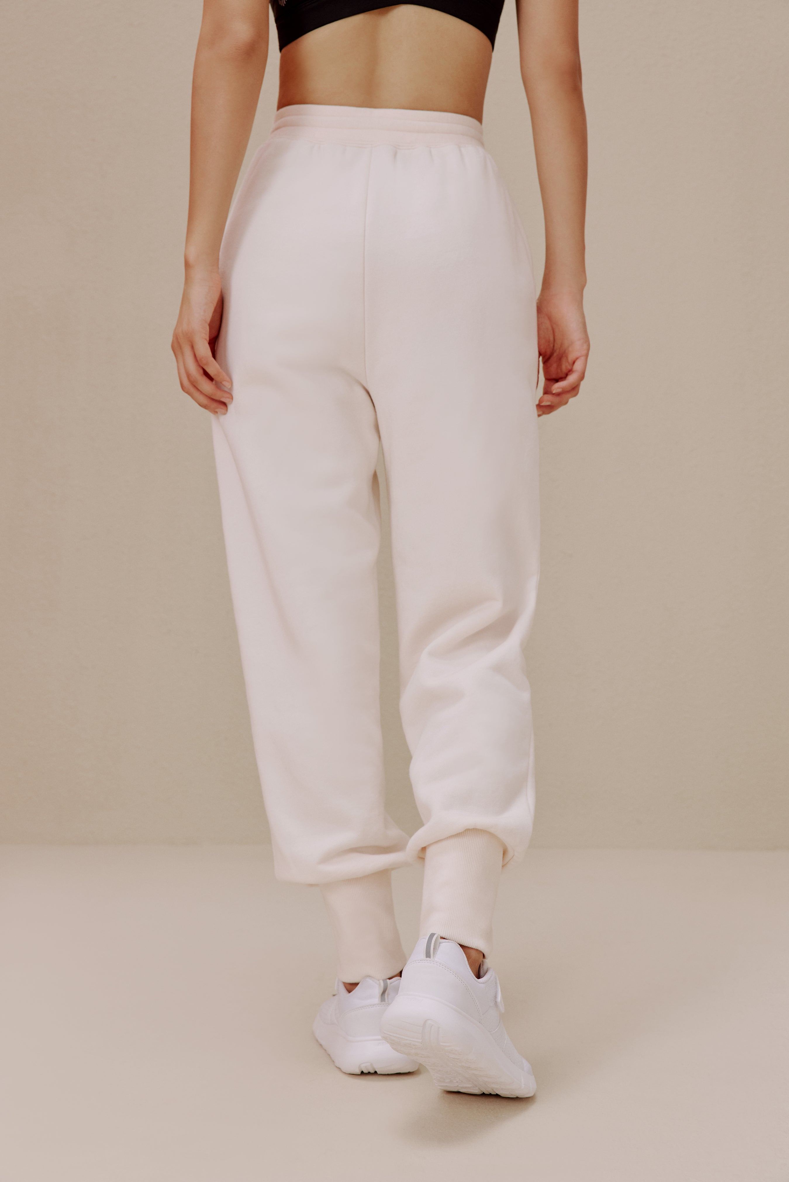 back of women in white pants