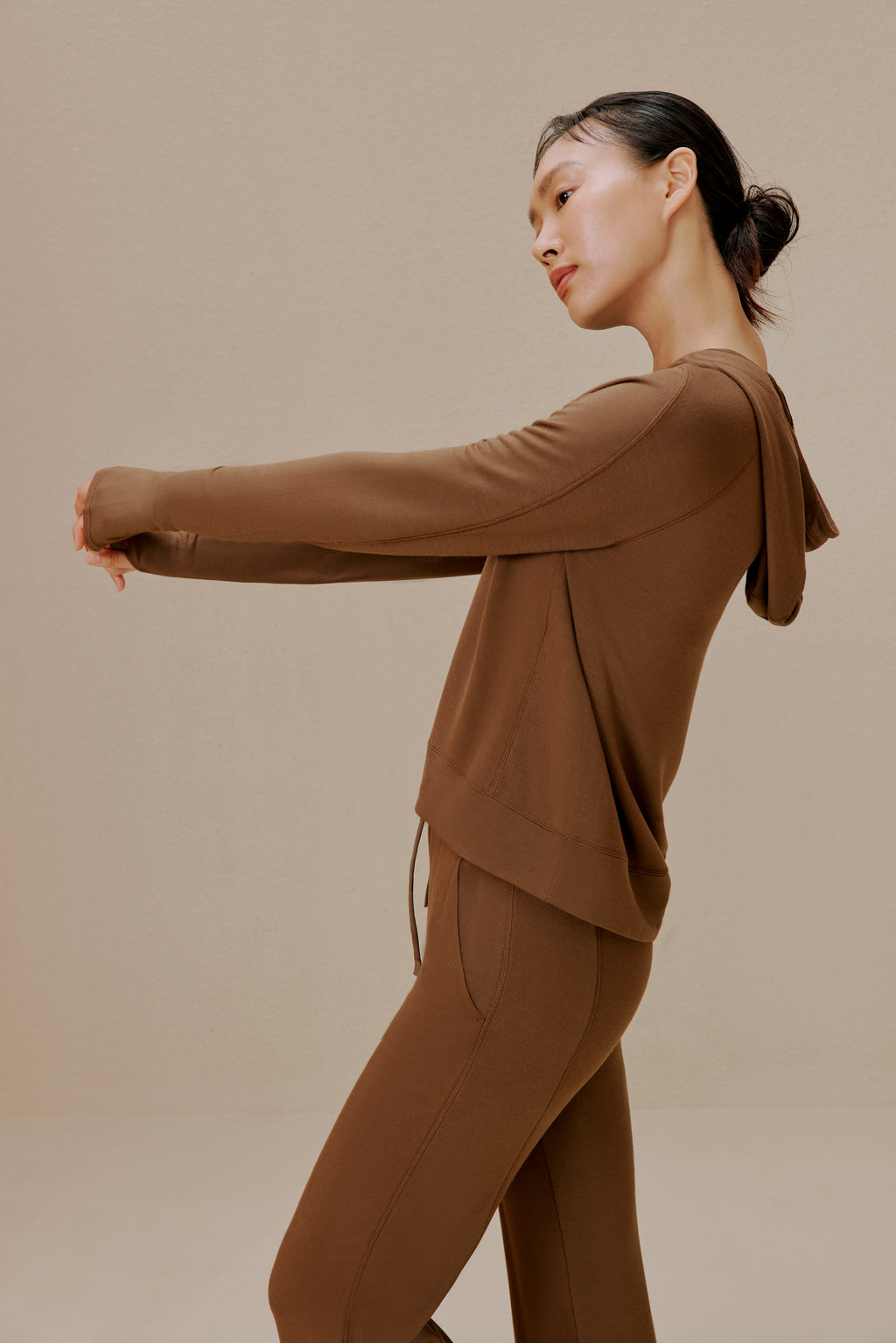 Side view of woman wearing brown pants and brown top