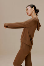 Side view of woman wearing brown pants and brown top