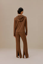 Back of a woman wearing brown pants and brown top