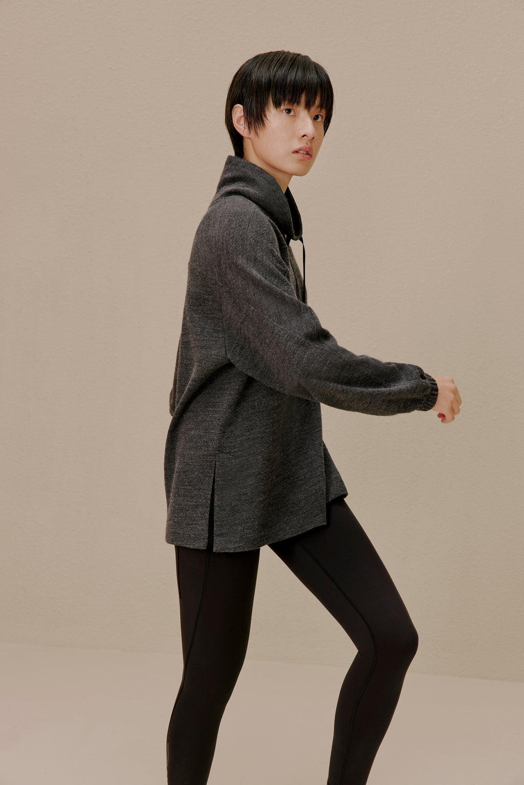 Side view of woman in black pullover