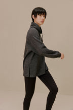 Side view of woman in black pullover