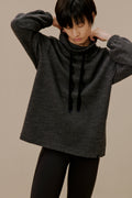 Woman in black pullover