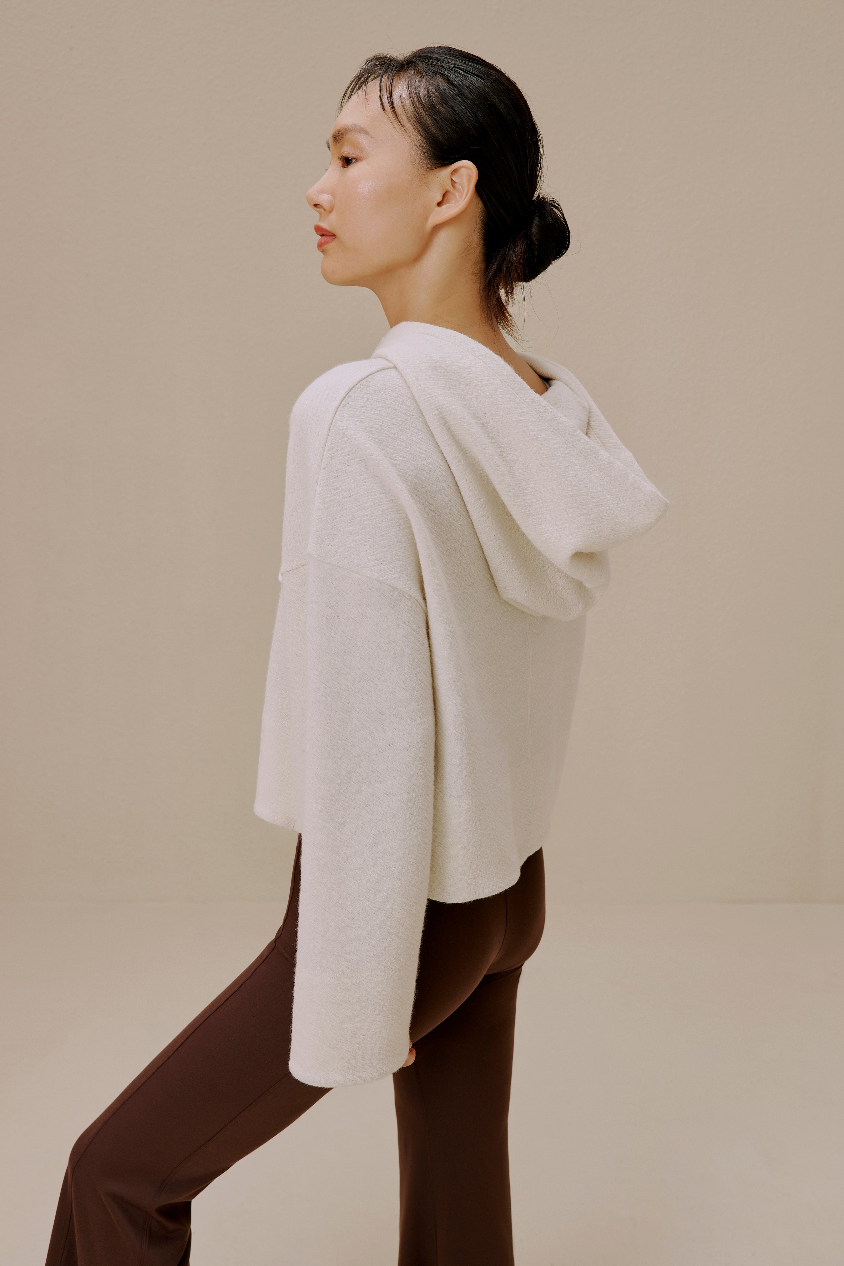 Side view of woman in white sweater