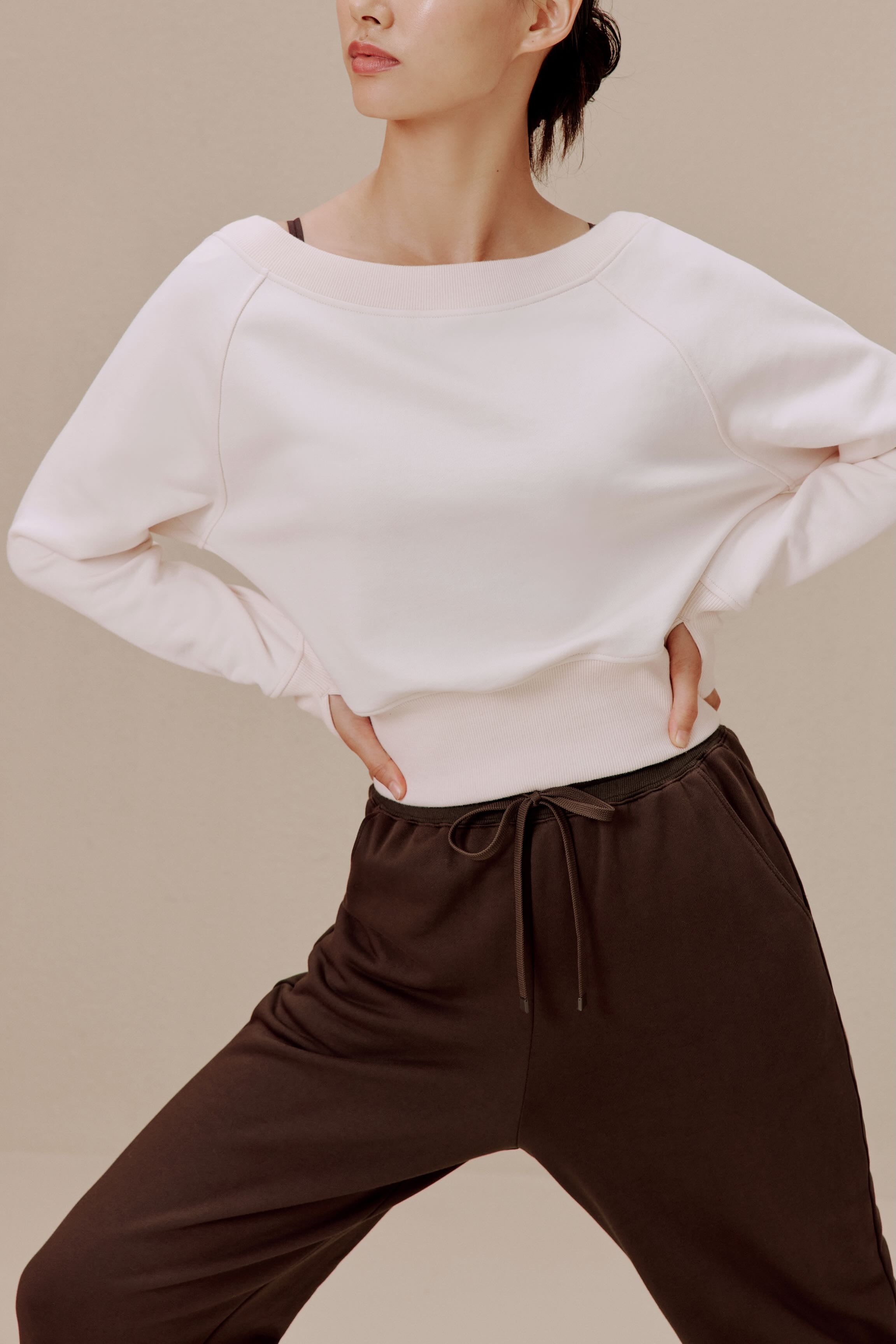 women in the white top and brown pants