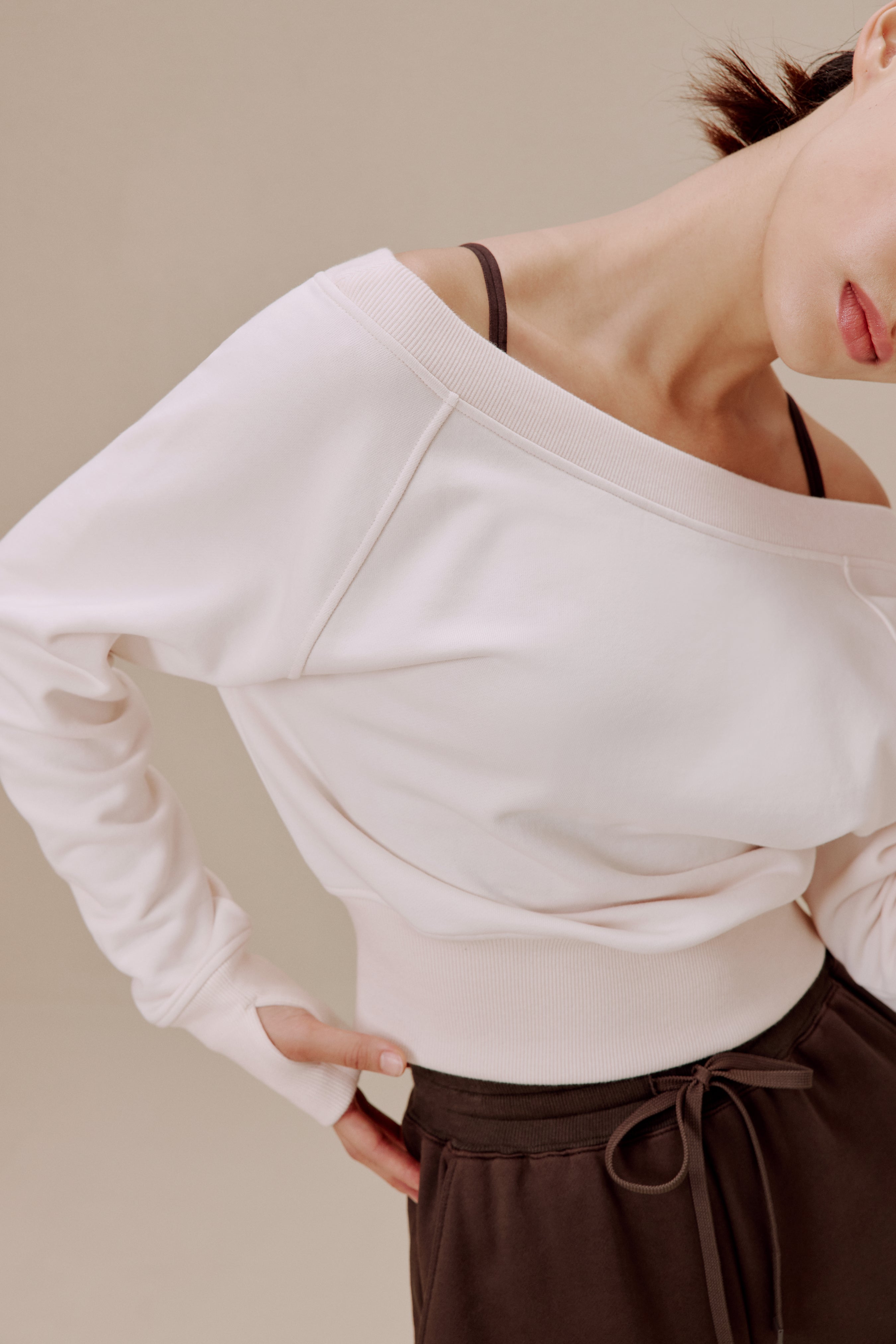 women in the white top and brown pants