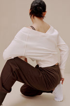 back of women in the white top and brown pants