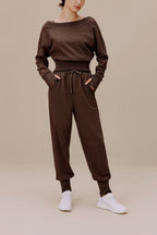 women in the brown top and brown pants