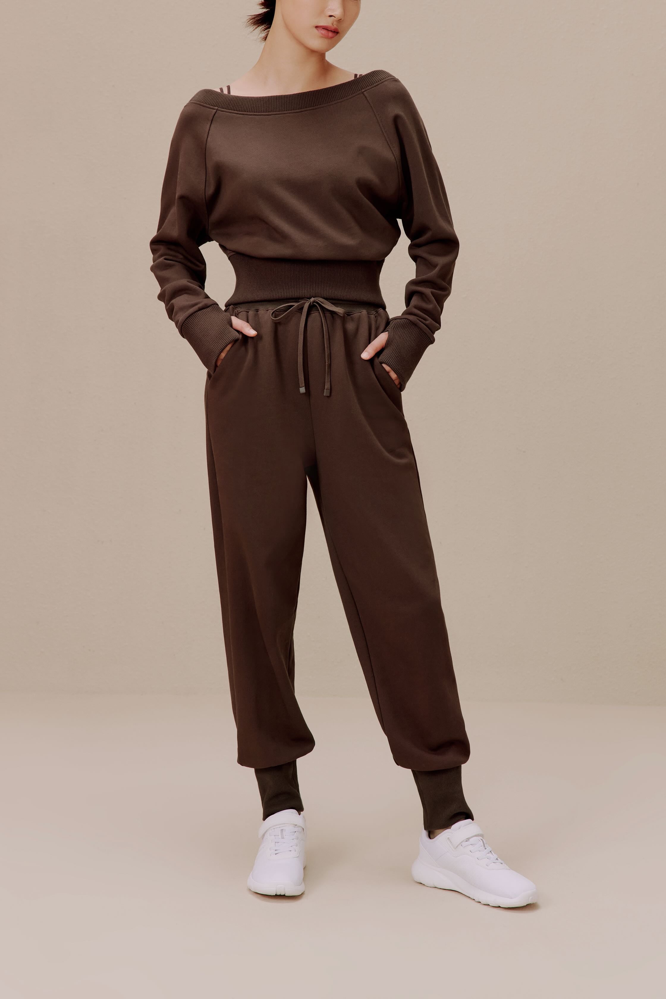 women in the brown top and brown pants