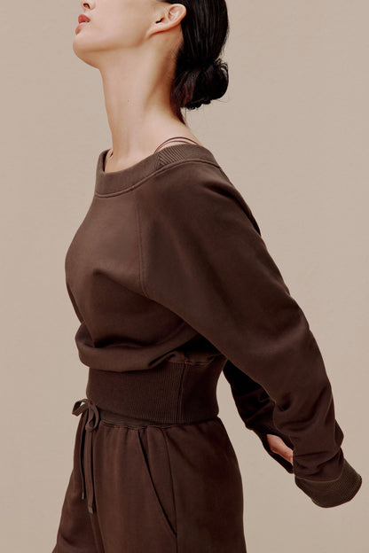 side of women in the brown top