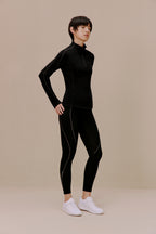 Woman in black top and leggings