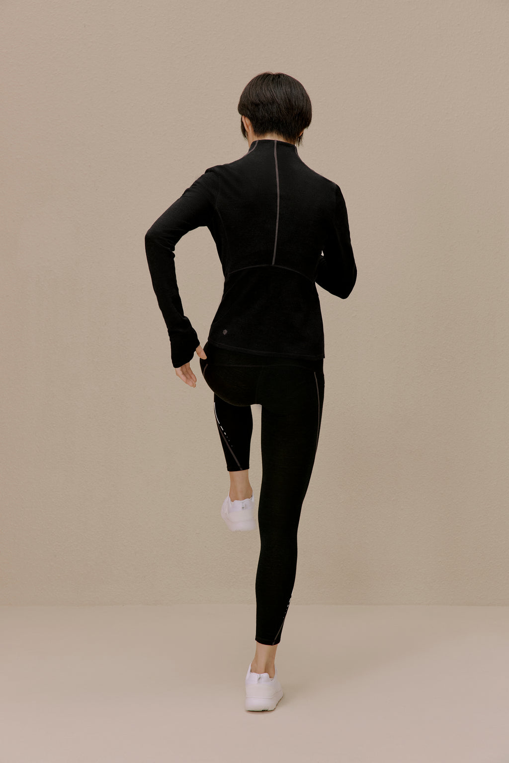 back of women in black active top and leggings