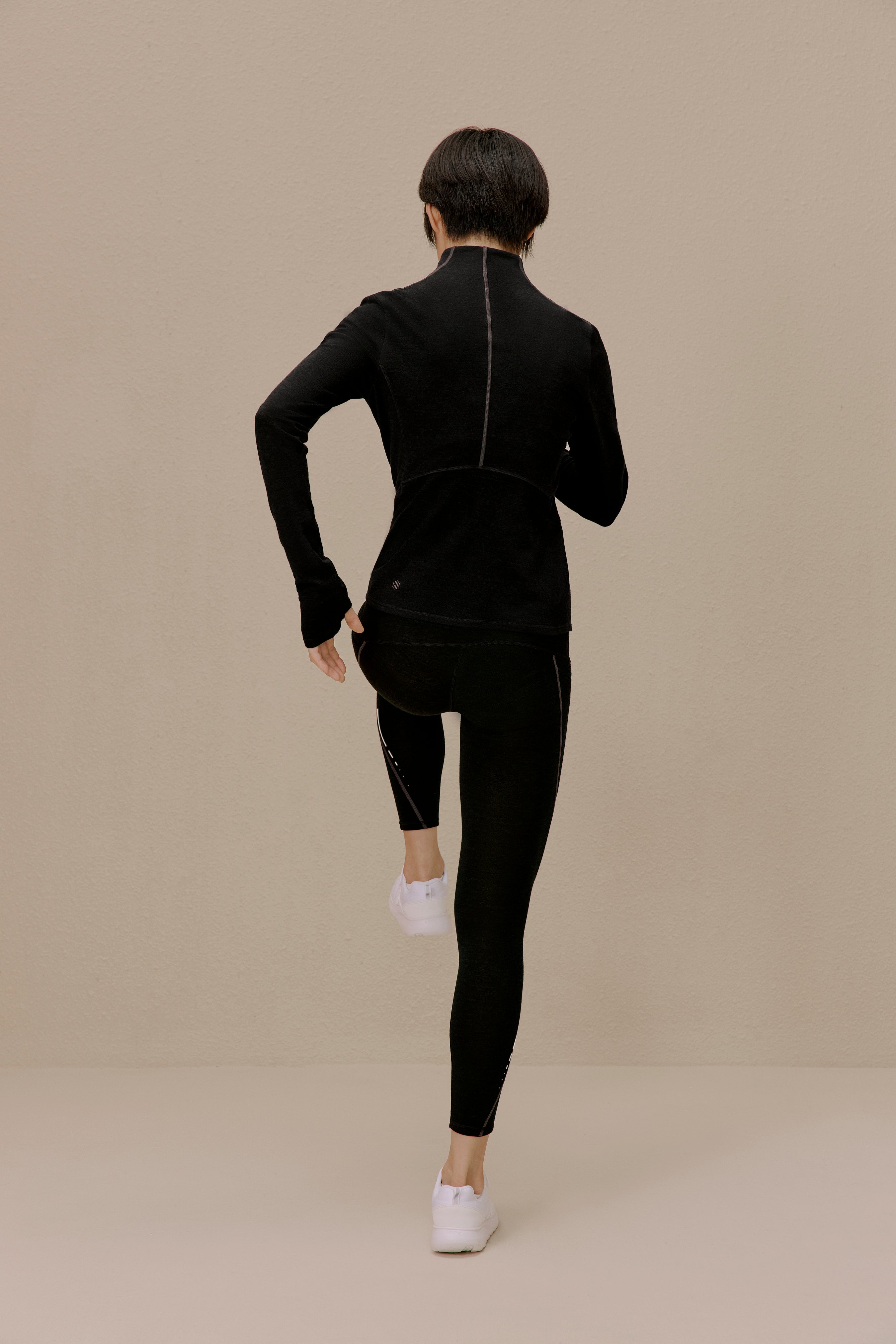 back of women in black active top and leggings
