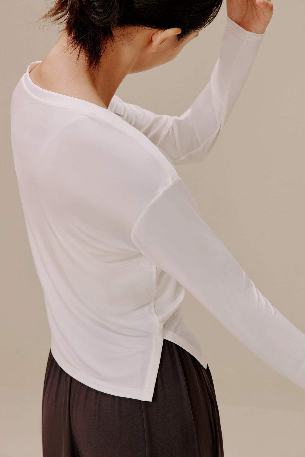 Back of woman in white top and pants
