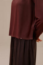 close of woman in brown top and pants