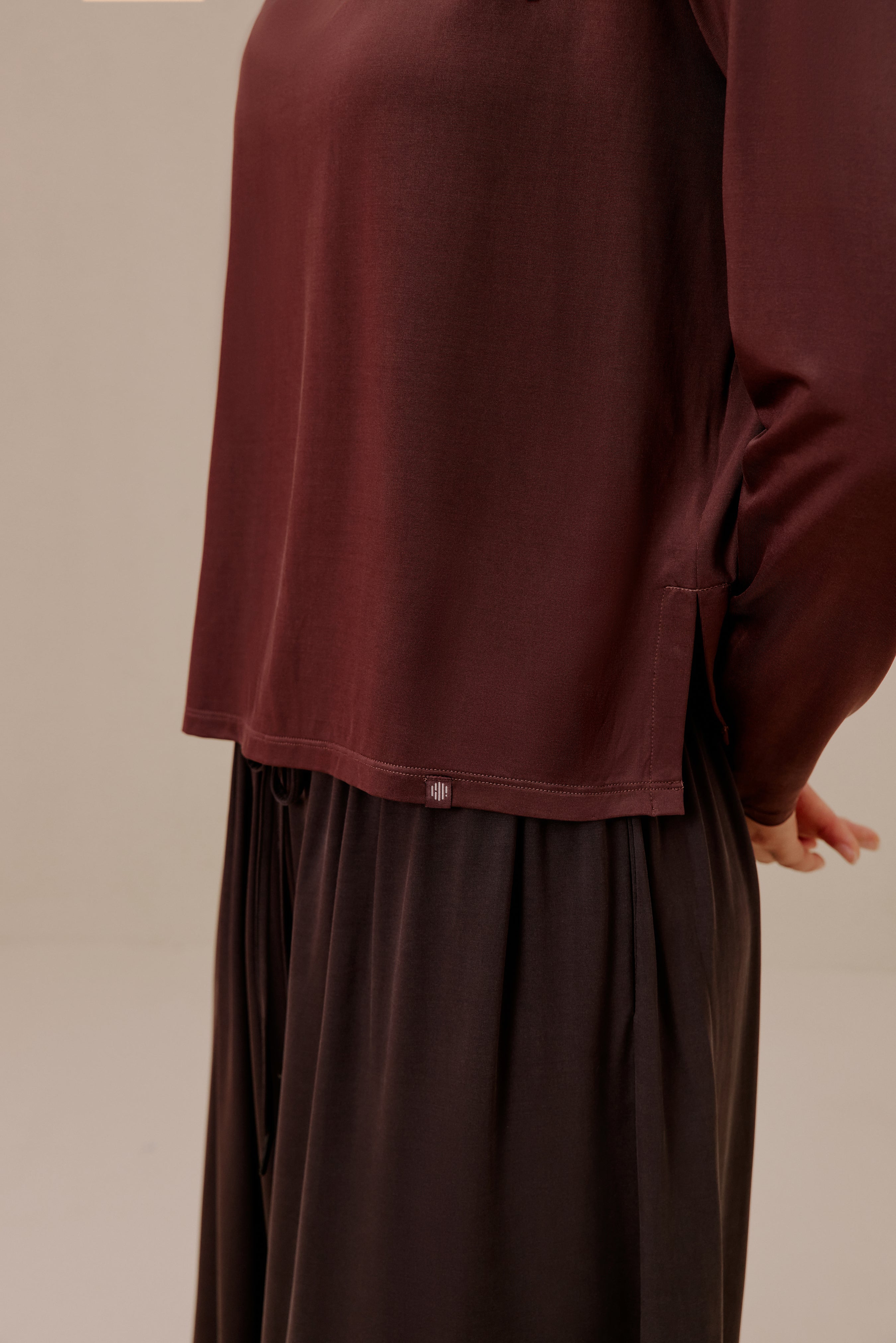 close of woman in brown top and pants