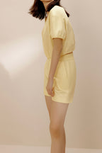 Side view of model wearing yellow top and yellow shorts.