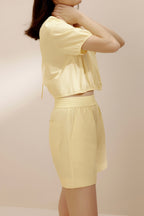 Side view of woman wearing yellow top.