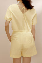 Back view of woman wearing yellow top.
