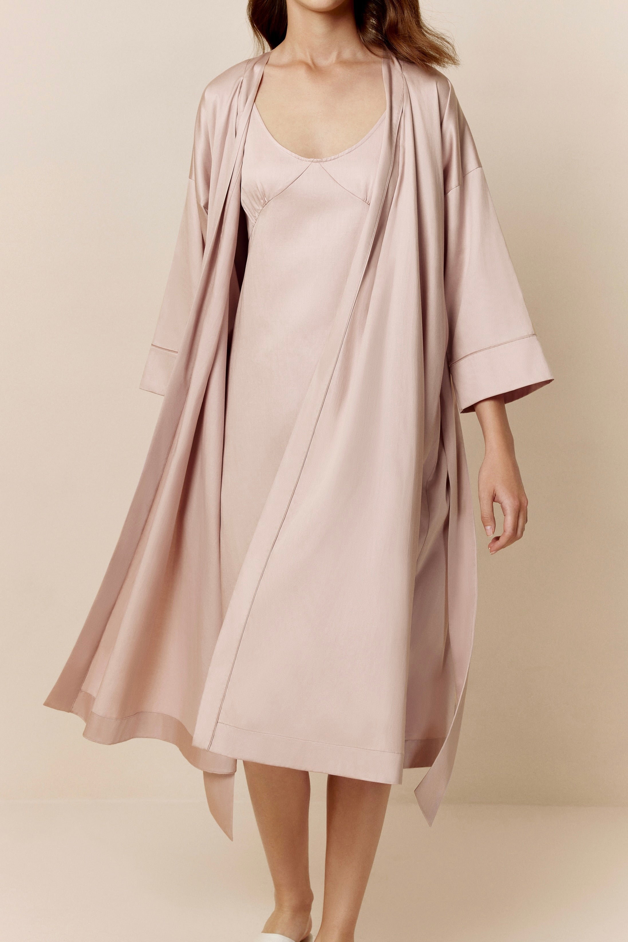 woman in light pink long pajama robe and pajama dress