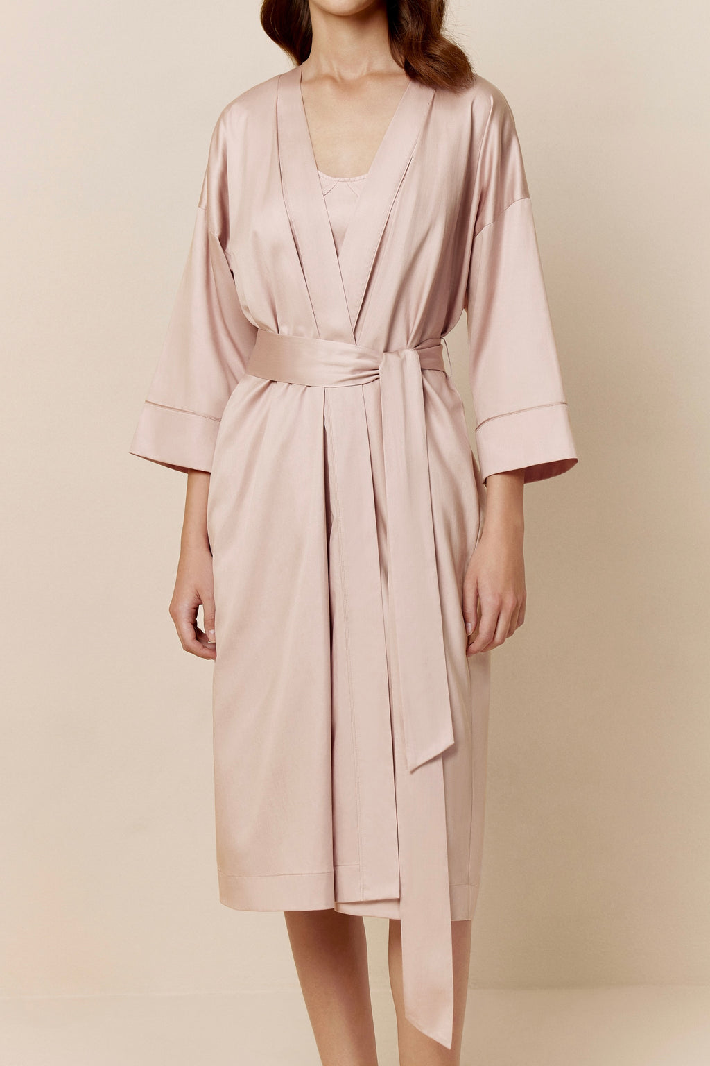 woman in light pink long pajama robe and pajama dress