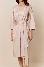 woman in light pink long pajama robe and pajama dress