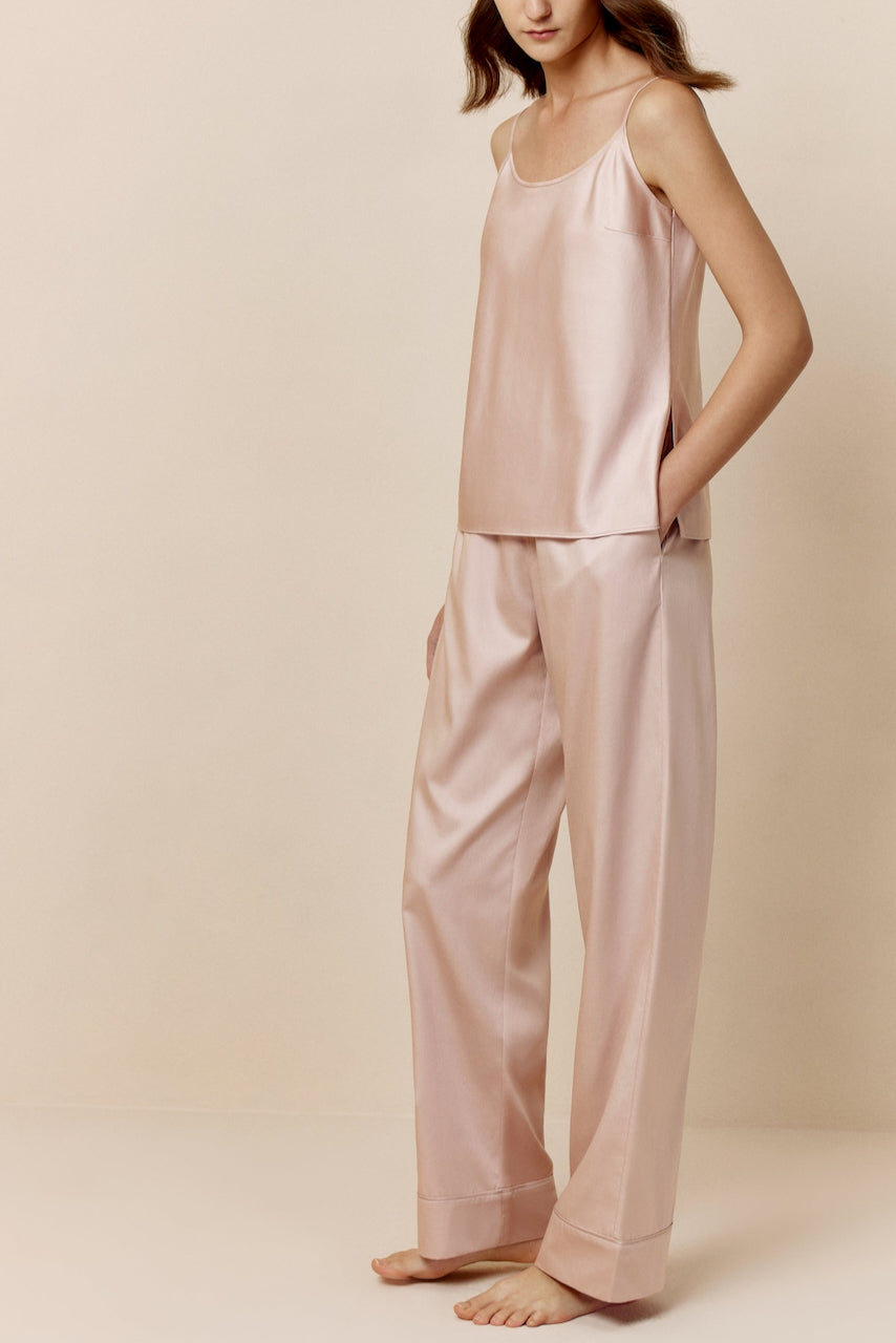 Woman in light pink camisole and pants
