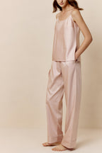 Woman in light pink camisole and pants