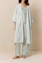 woman in blue blush long pajama robe and pajama set