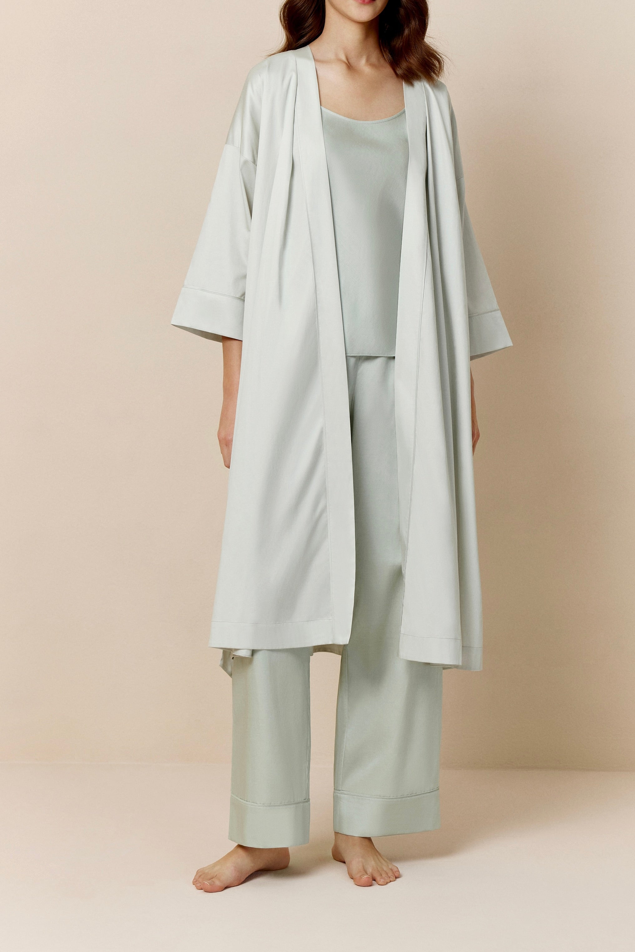 woman in blue blush long pajama robe and pajama set