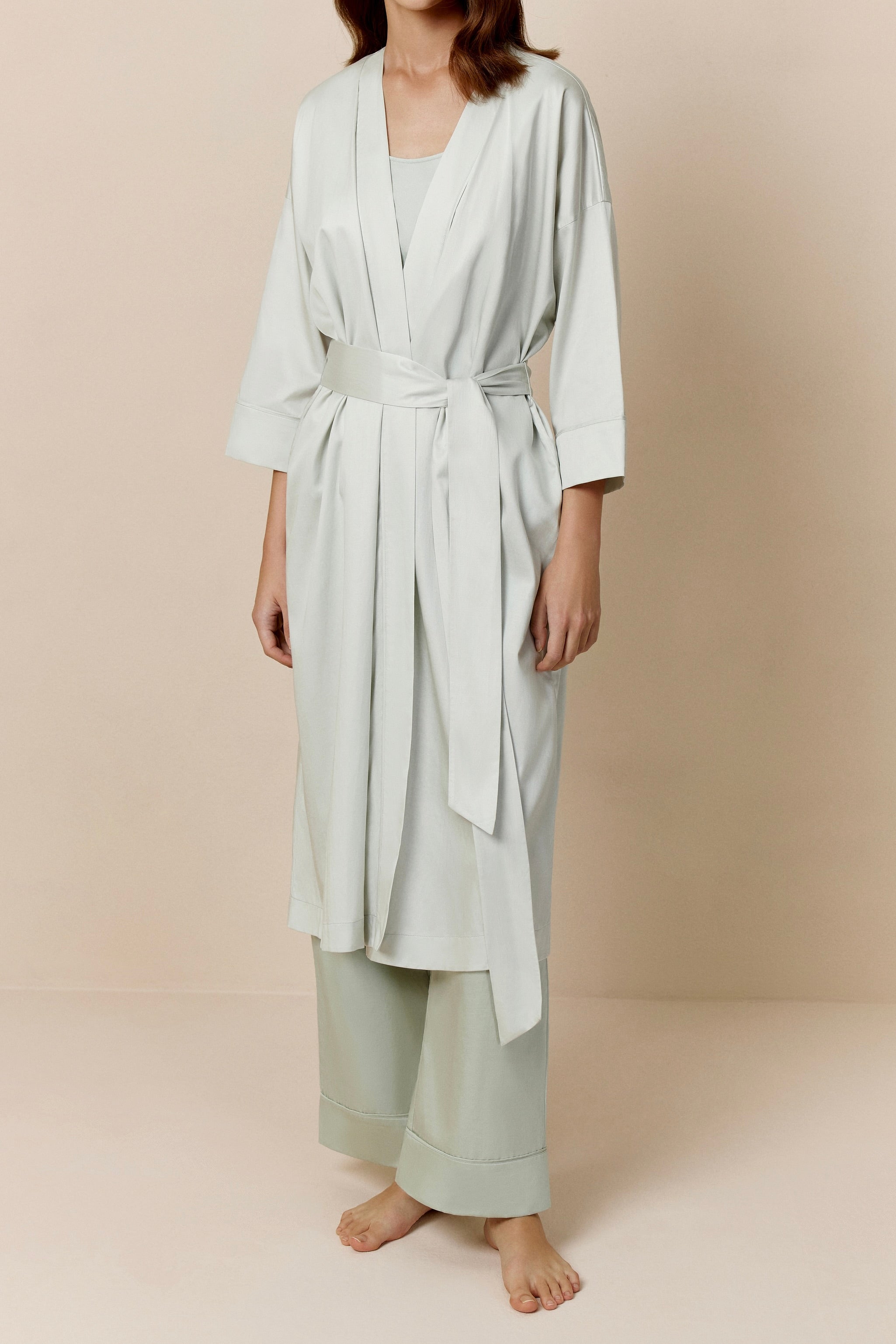 woman in blue blush long pajama robe and pajama set