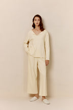 Woman in yellow top and pants.