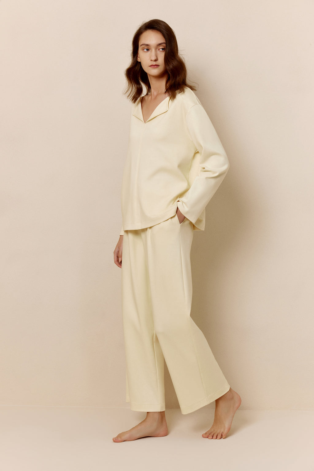 Side view of woman in yellow top and pants.