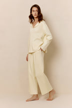 Side view of woman in yellow top and pants.