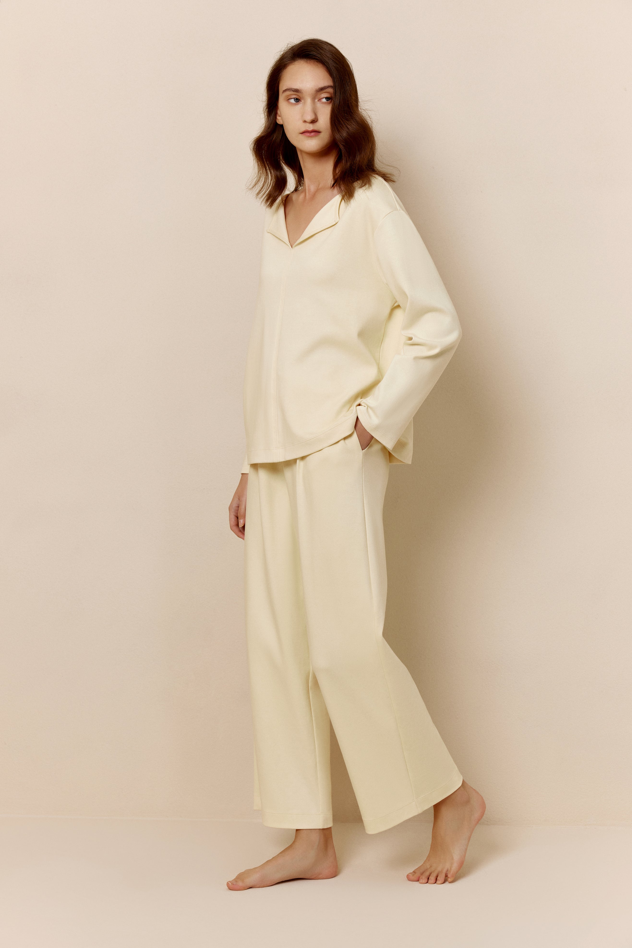 Side view of woman in yellow top and pants.