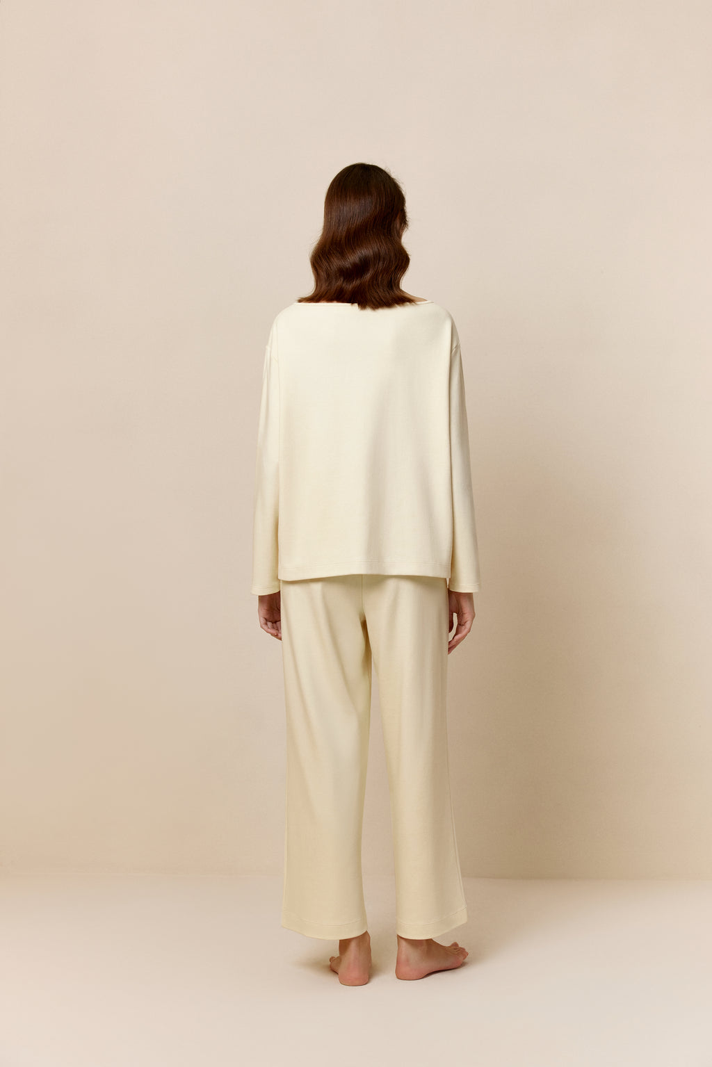 Back view of woman in yellow top and pants.