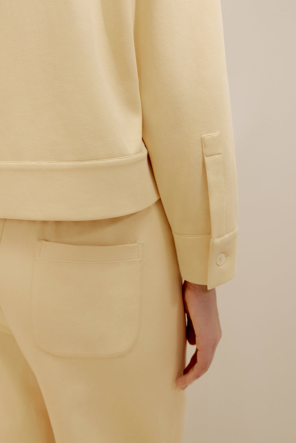 close up view of the yellow polo shirt and pants