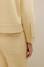 close up view of the yellow polo shirt and pants