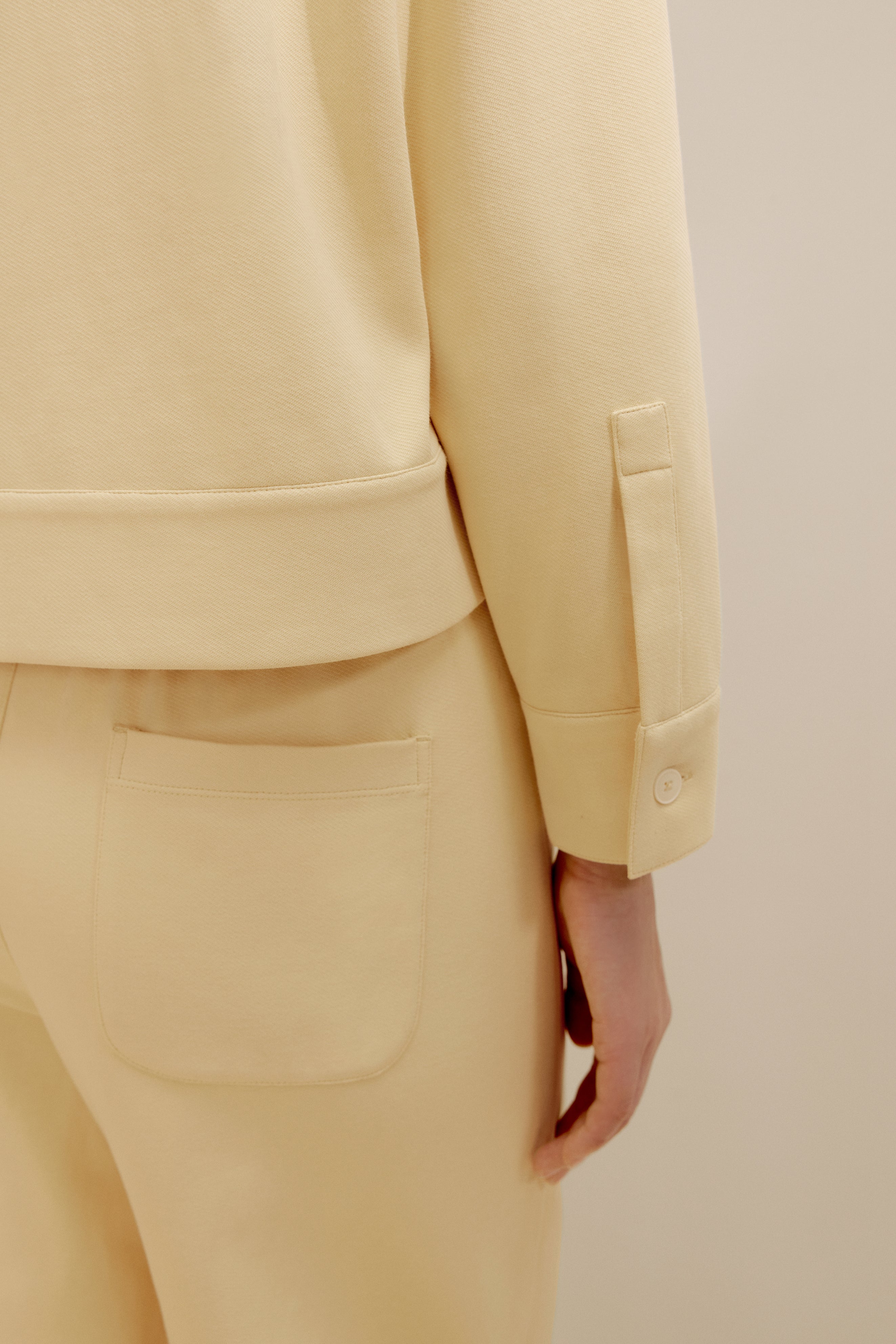 close up view of the yellow polo shirt and pants
