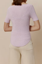 Back view of woman in purple short-sleeved shirt