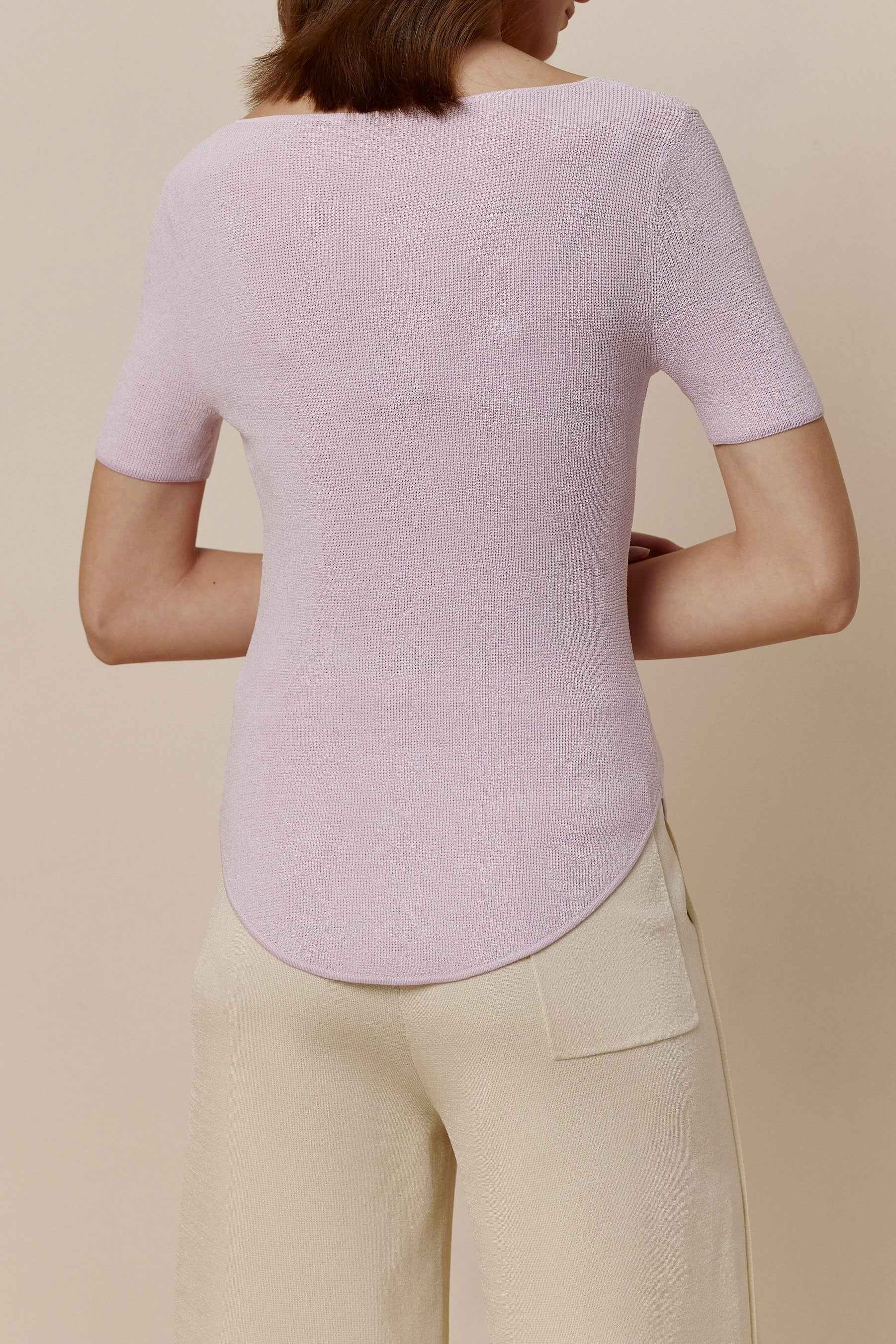 Back view of woman in purple short-sleeved shirt