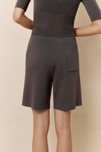 Back view of woman wearing gray knit shorts.