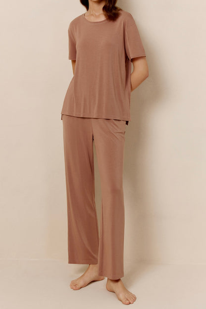 Woman wearing dusty rose short sleeve pajama shirt and matching pants