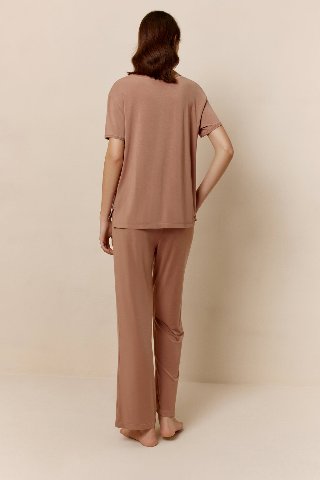 Back of woman wearing dusty rose short sleeve pajama shirt and matching pants