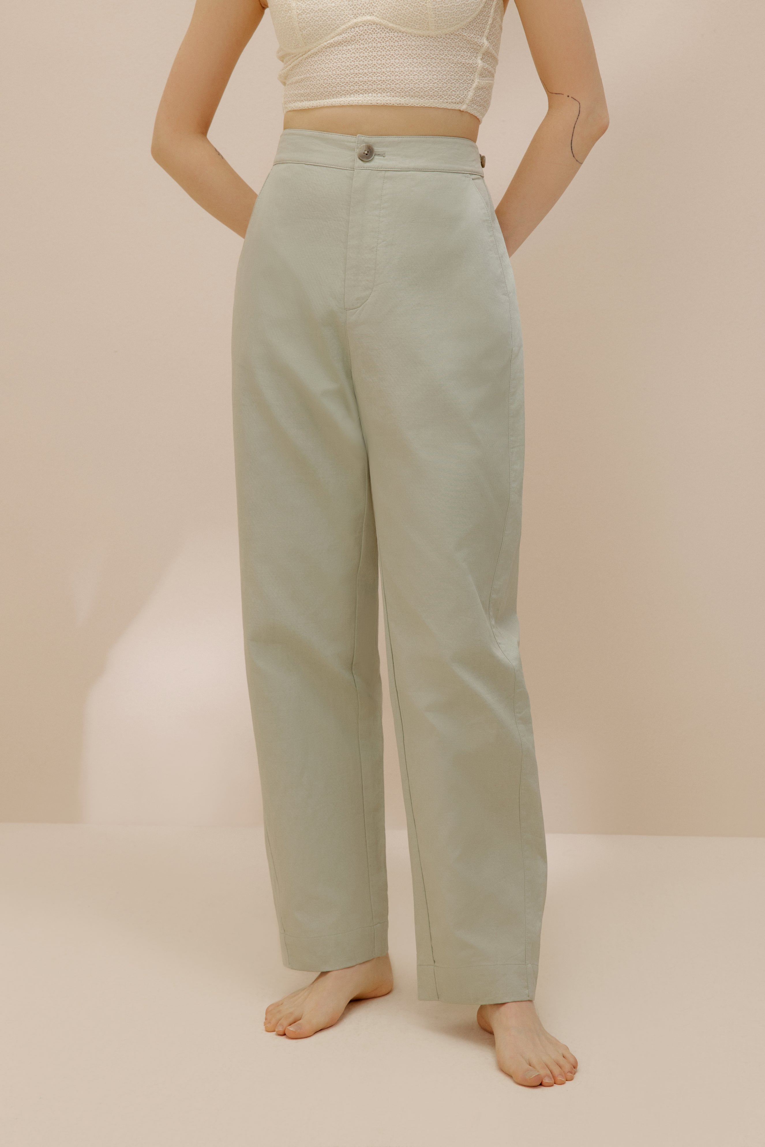 Front view of model wearing light green pants.