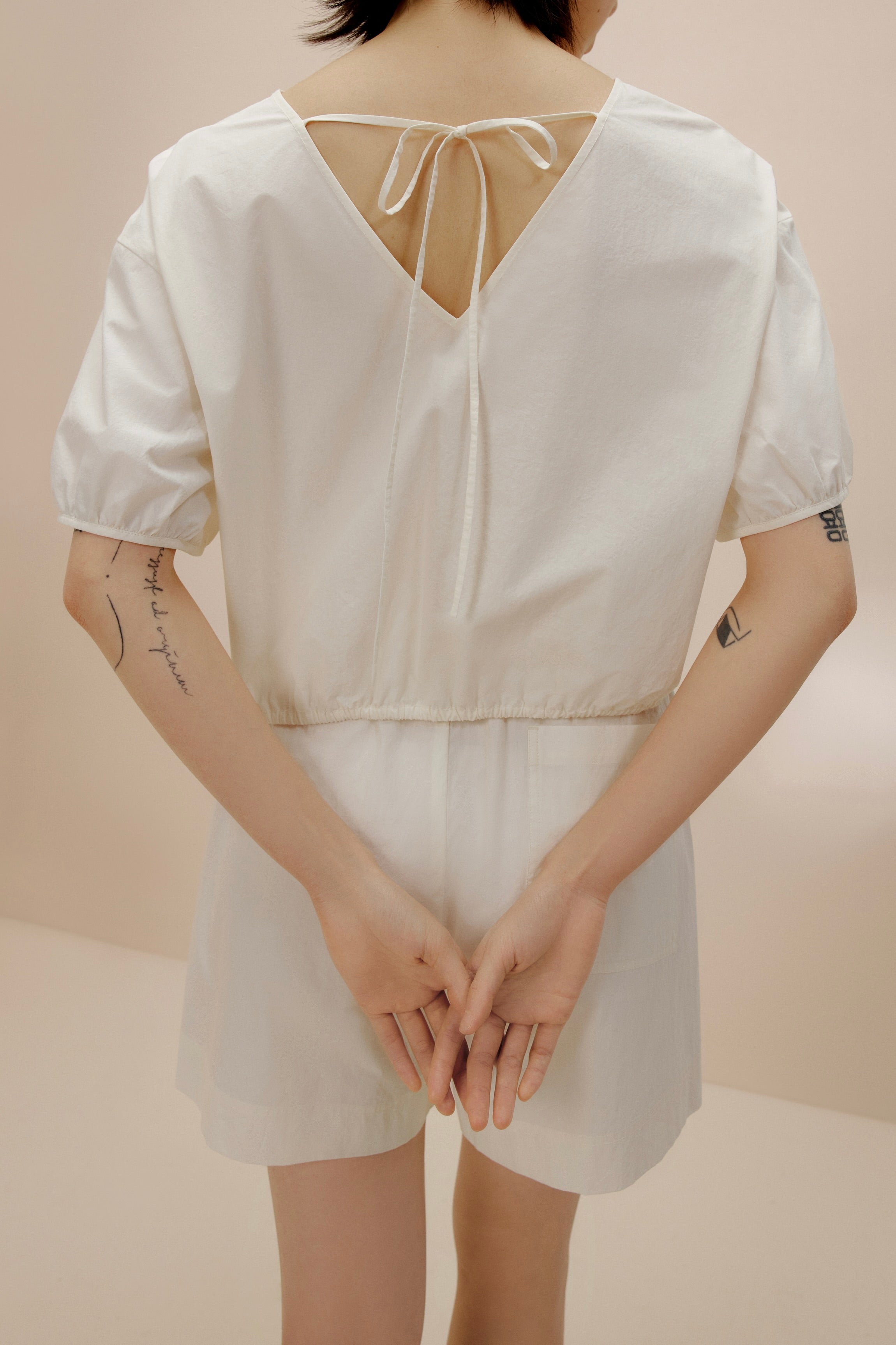 Back view of woman wearing white top.